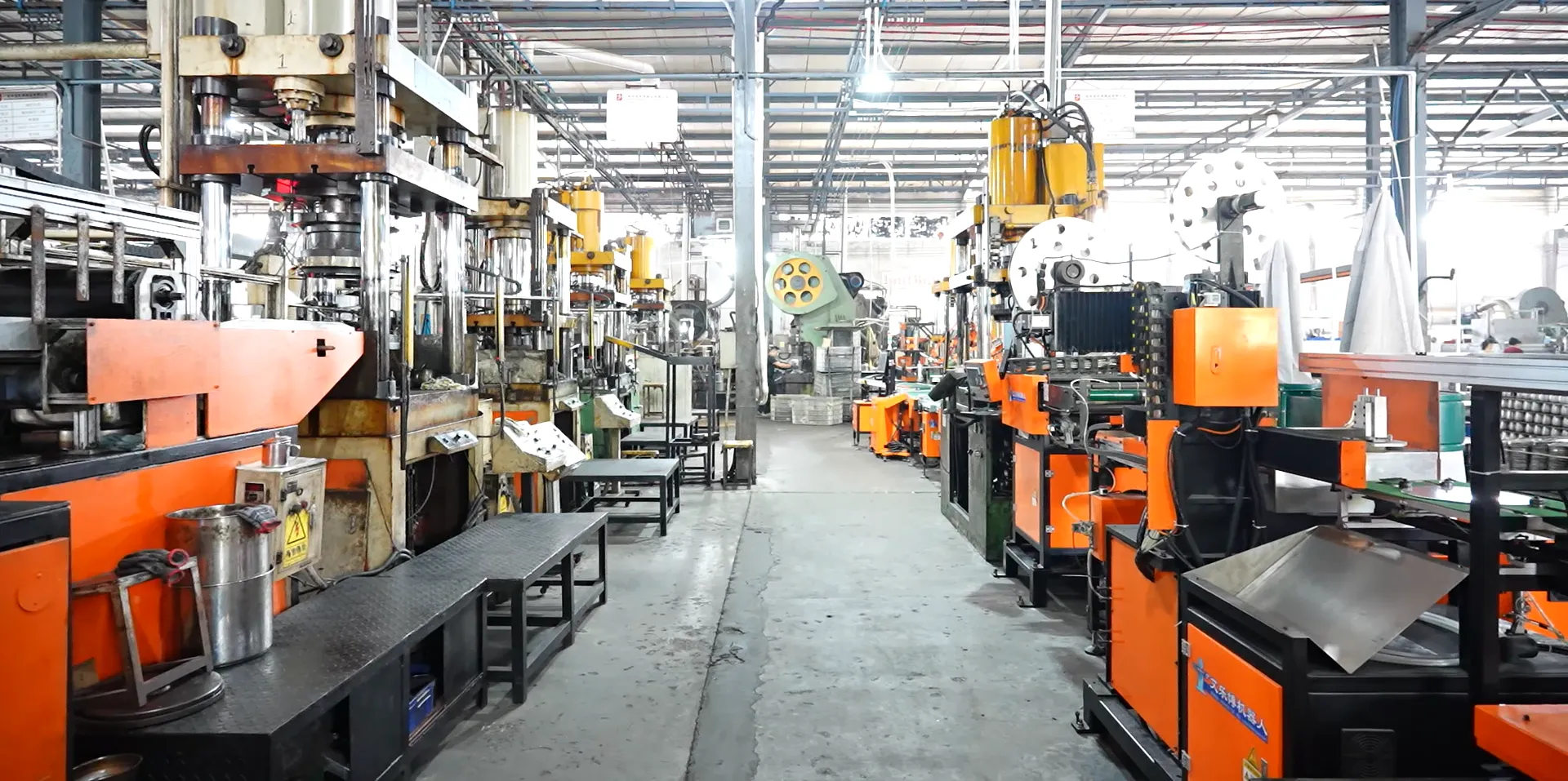 Aisles of hydraulic presses in a stainless steel cookware factory stamping shop, the scale evidence that separates manufacturers from trading companies